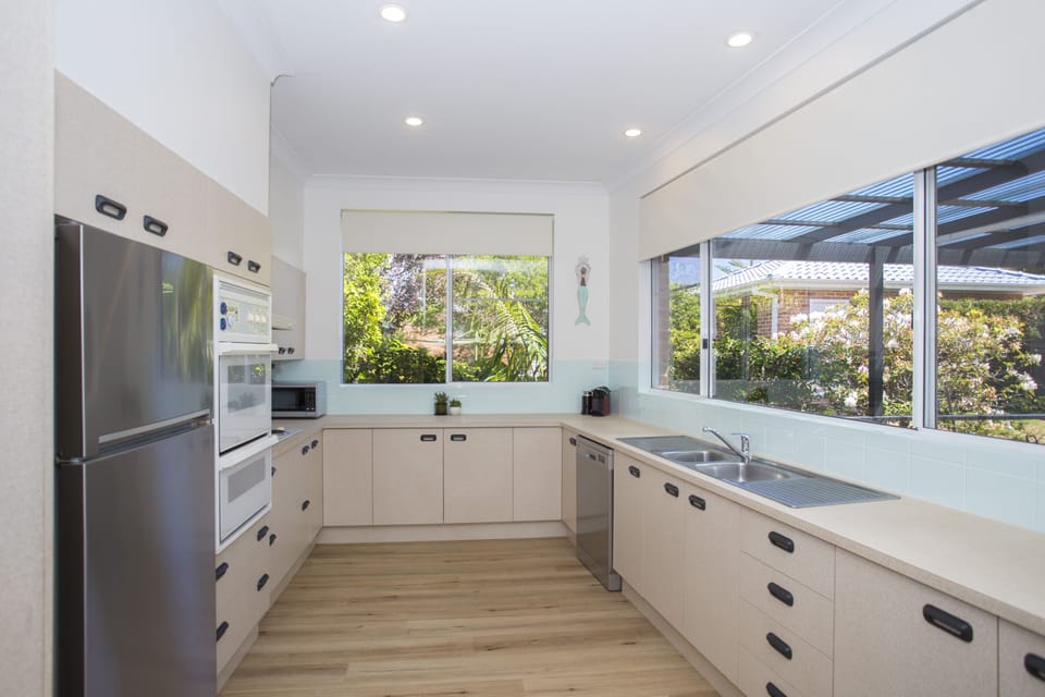 Kitchen with large fridge, dishwasher, microwave, coffee machine, well stocked 