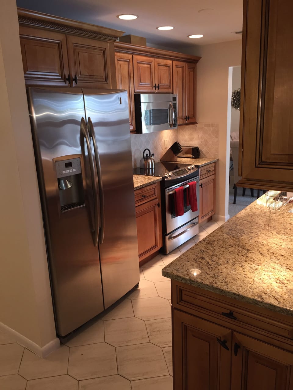 Kitchen with microwave and double door refrigerator with ice & water