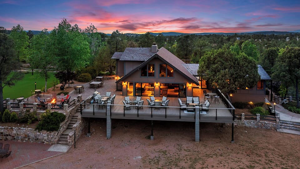 Expansive deck with cozy seating, warm lighting, and beautiful scenic views.