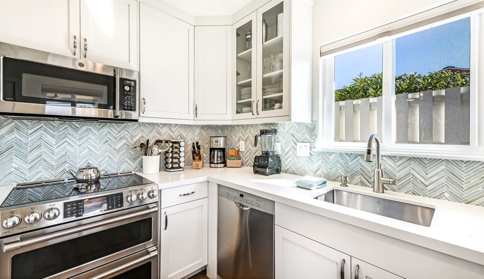 The kitchen features high-end All-Clad cookware, spices, and kitchen tools for the cooking enthusiast.
