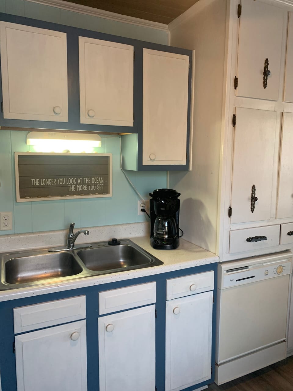 Well-lit kitchen with lots of cabinet space 