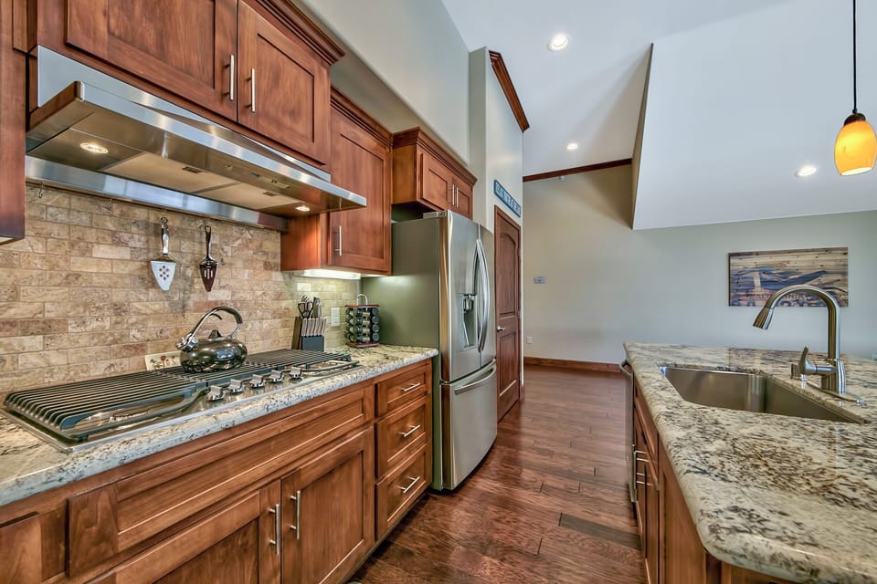 Your gourmet kitchen awaits with granite counters, rich cherry cabinets, and premium stainless appliances for unforgettable meals.