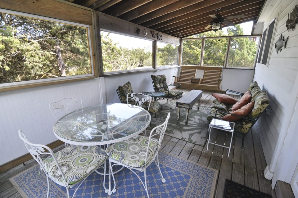 Rear Screened Porch with Seating and Dining Table