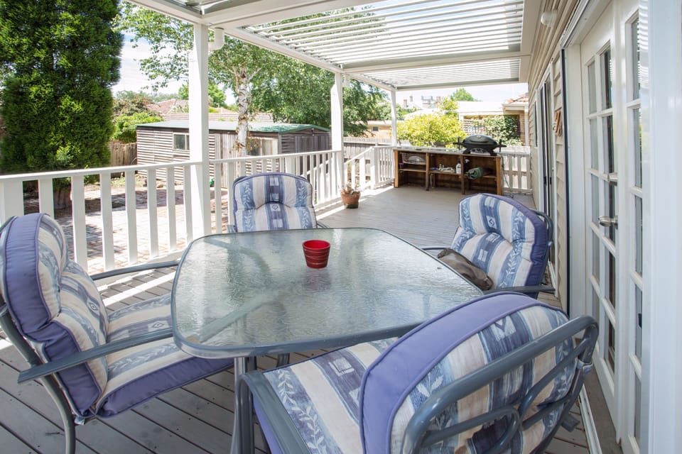 Large patio with comfortable chairs and BBQ attached to natural gas 