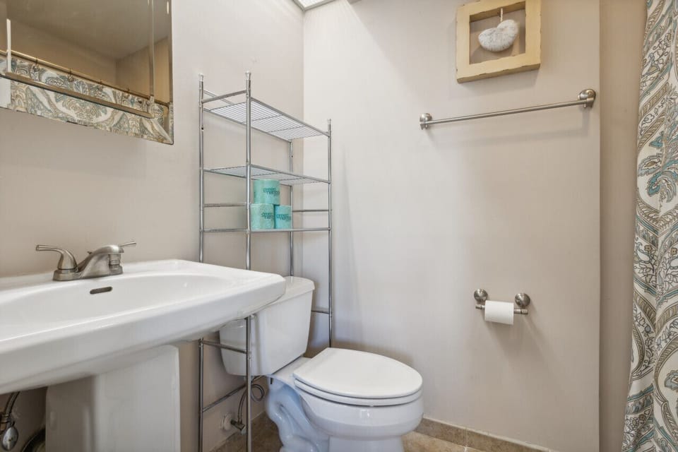 The hall full bathroom features a tub shower for the hall closet and living room access.