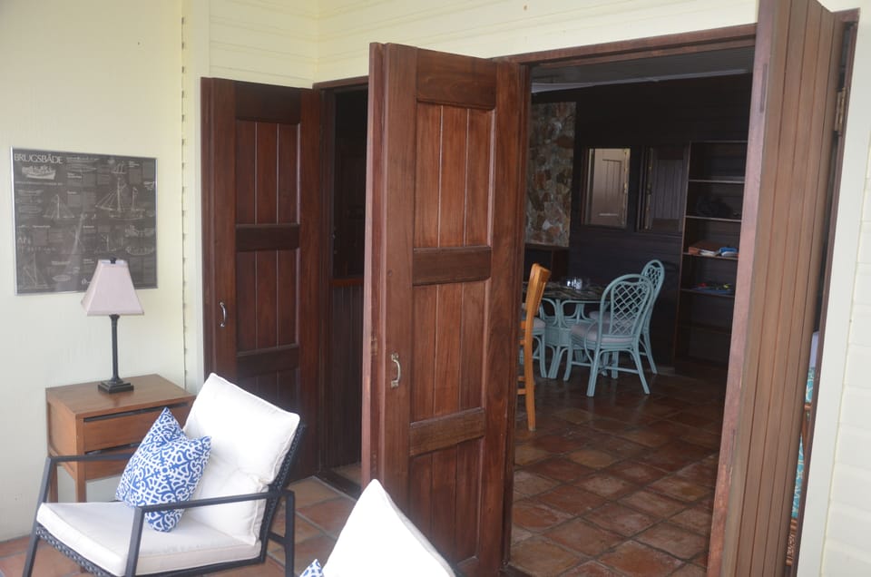 double, double brazilian doors open from sunroom into living room.
