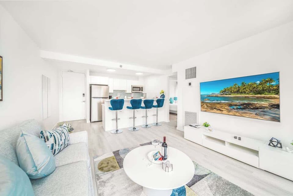 Relax and enjoy your favorite shows and movies on the 65-inch smart TV in the comfortable living area, perfectly complemented by the open-concept design and stylish kitchen.