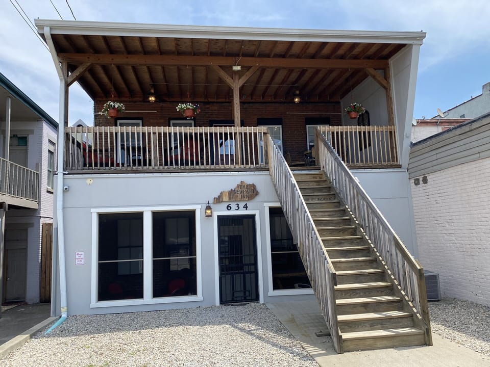 Rear of the building with upper deck, screened porch and free parking lot! 
