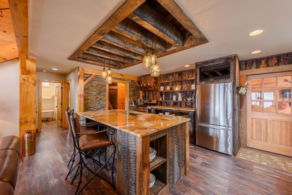 Custom Central Island with Bar Stool Seating and Coffered Accent Ceiling