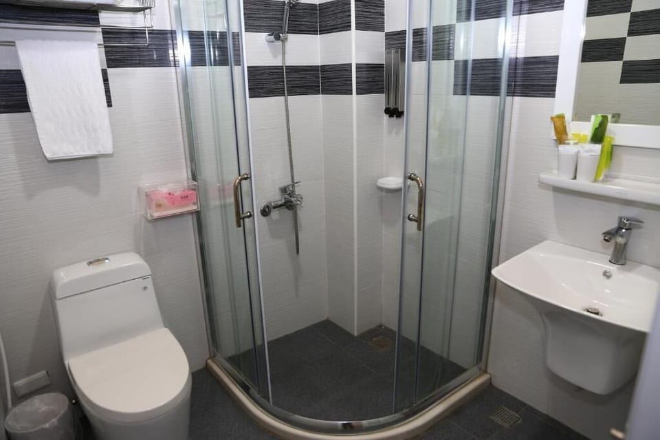 Shower, hair dryer, slippers, towels