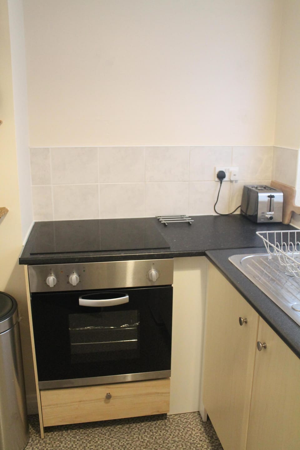 Modern kitchen with fan oven and ceramic hob.