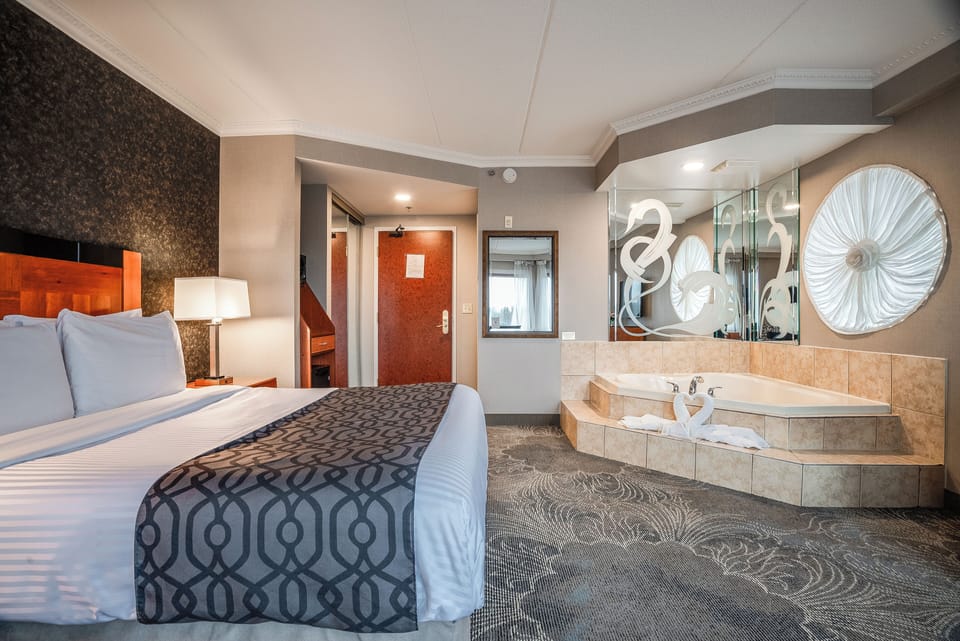 Queen Suite with Jetted Tub | Down comforters, in-room safe, desk, blackout drapes