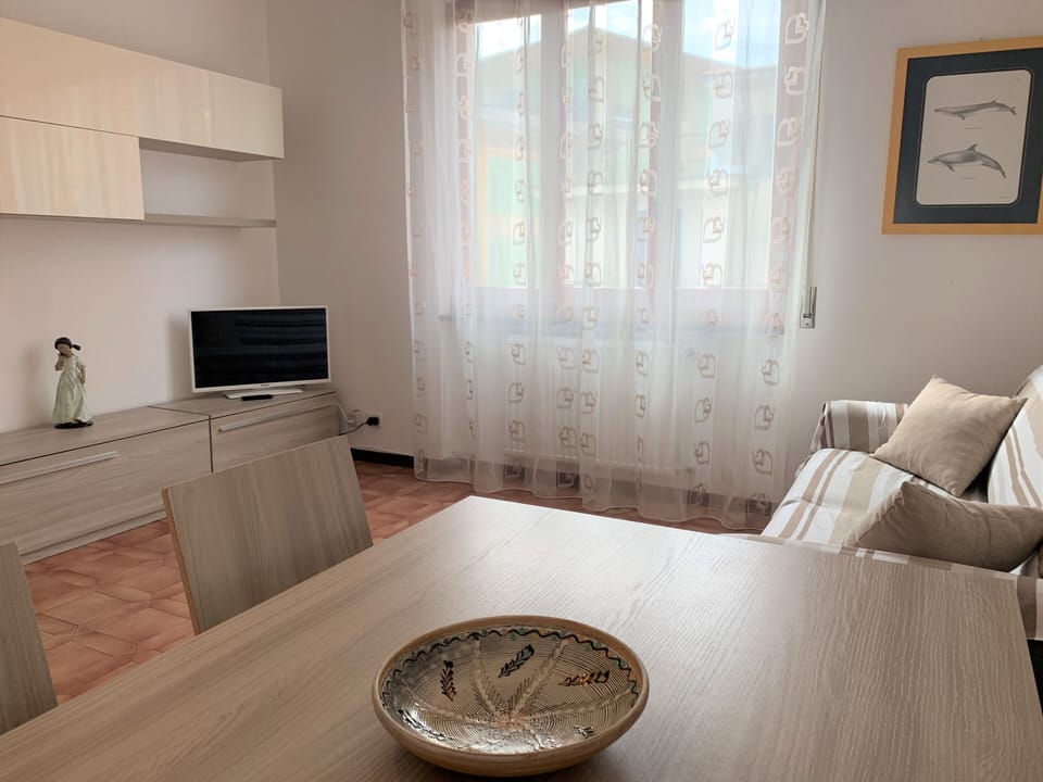 Apartment (Lella - Via Martiri della Libertà 24) | Living area | 20-inch TV with cable channels