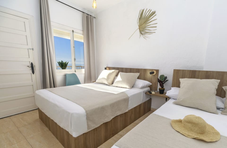 Superior Triple Room, Beach View | Iron/ironing board, free WiFi, bed sheets