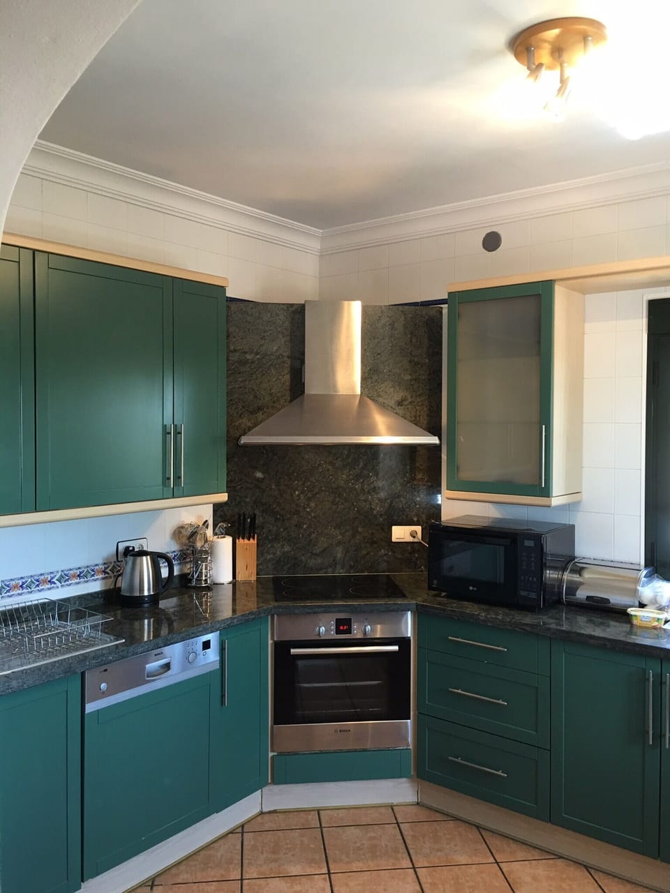 Kitchen with ceramic hob, fan oven, microwave/oven combo, dishwasher.