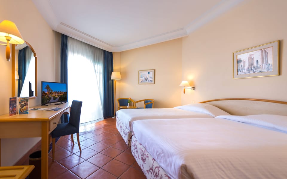 Family Triple Room | Minibar, in-room safe, blackout drapes, free WiFi