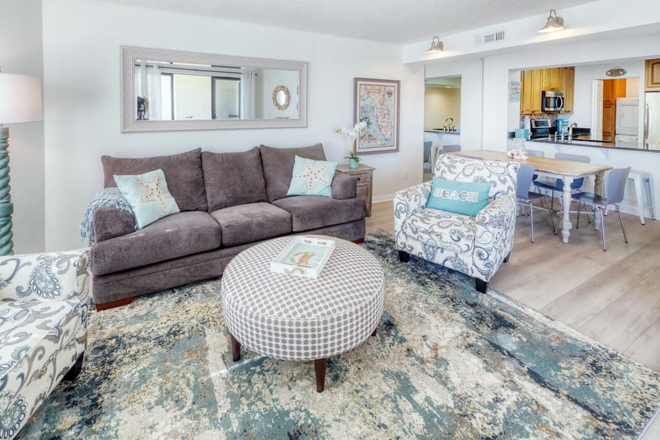 Living Room - Spacious living room with open floor plan and connected balcony featuring a direct view of the ocean.