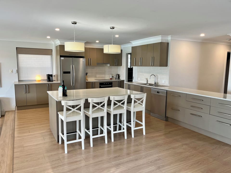 A enormous contemporary kitchen with plenty of room for all. 