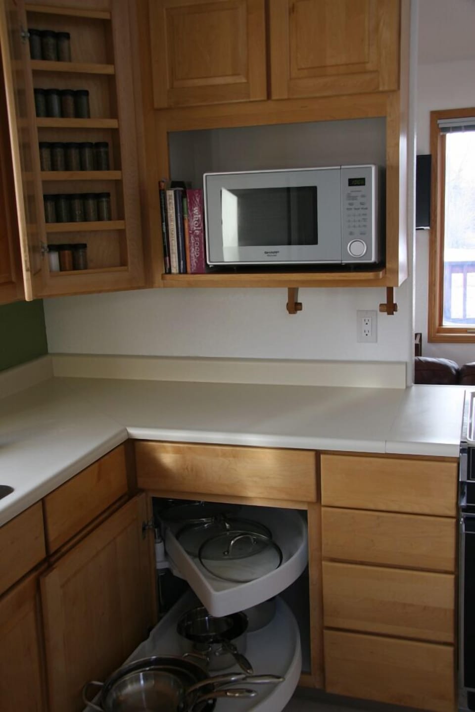 Kitchen with new microwave, new pots & pans and a nifty spice rack