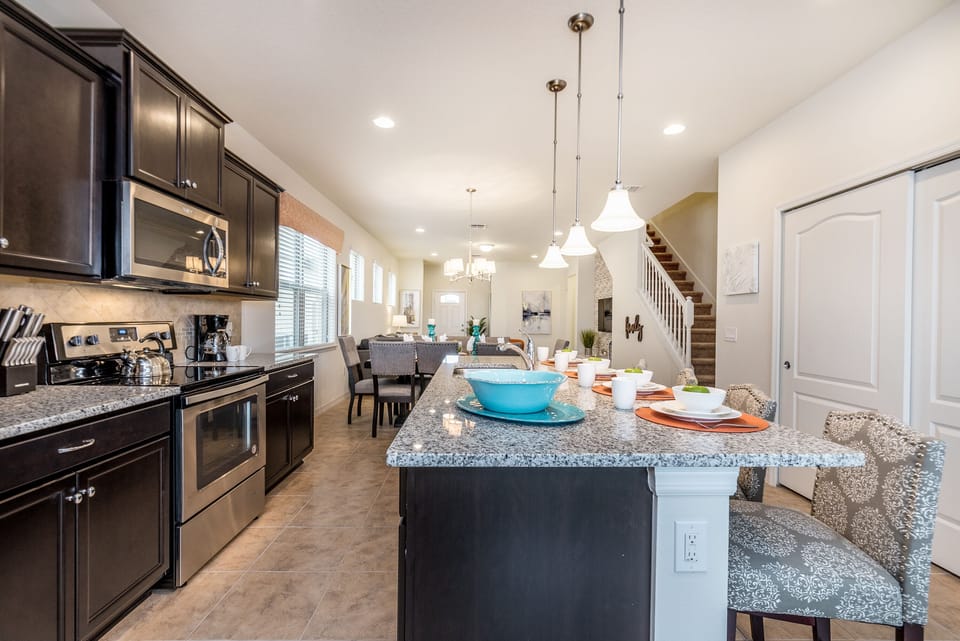 Kitchen Elegance: The kitchen, complete with a counter table, offers additional seating space for casual dining and lively conversations.