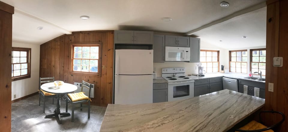 Dining and Kitchen with new appliances, spacious countertop and ample storage.