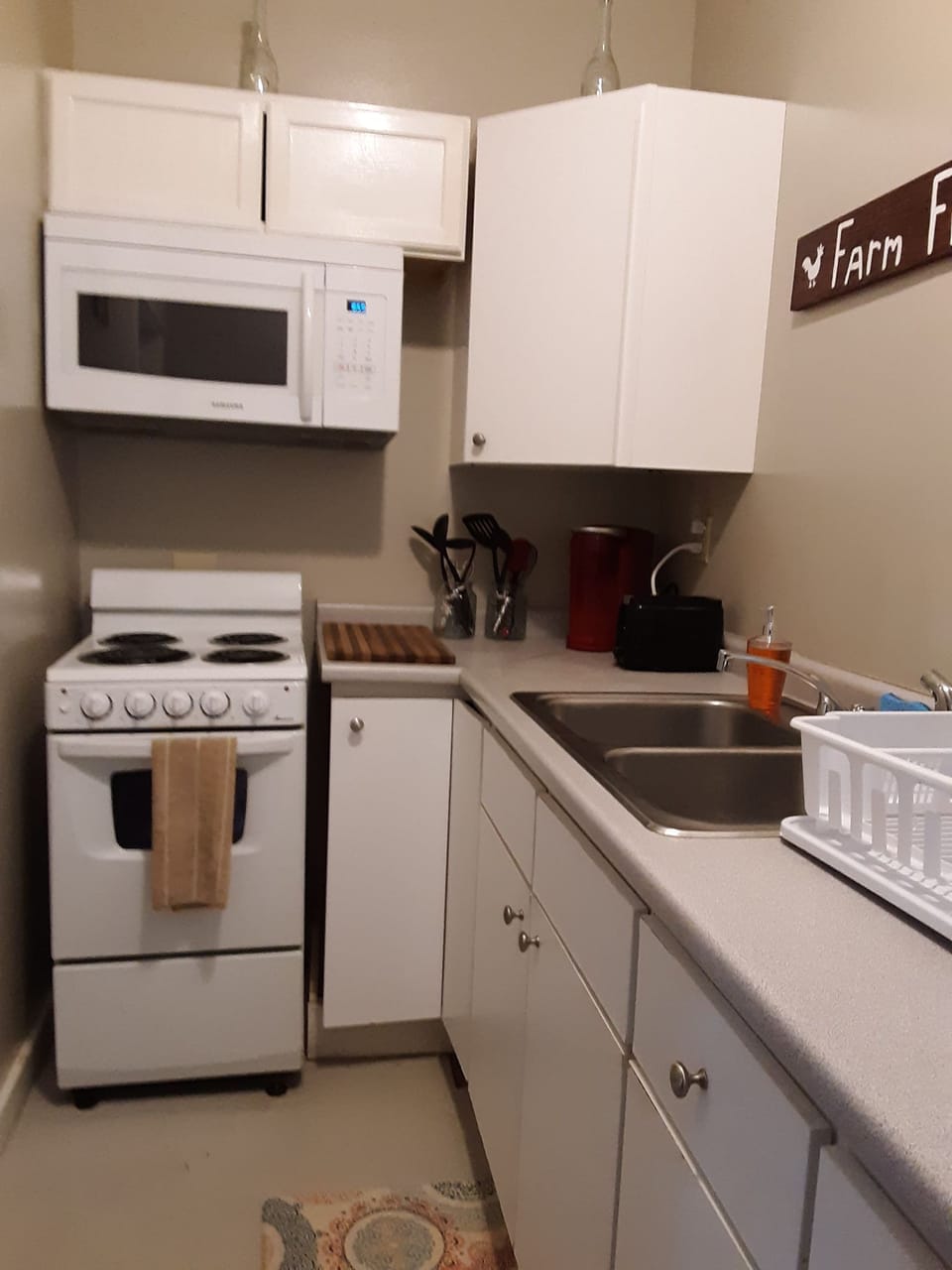 Efficiency kitchen stocked with dishware and cookware