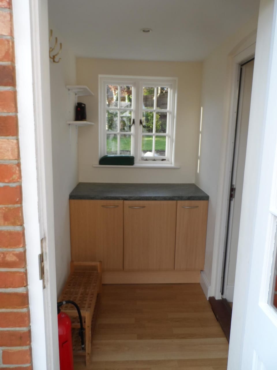 Utility room off kitchen with door onto patio