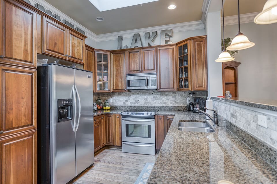 Fully stocked gourmet kitchen with custom cabinets, stainless, granite