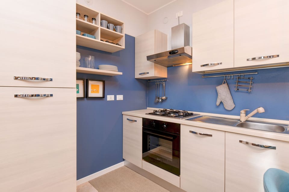Kitchen equipped with fridge, oven and microwave