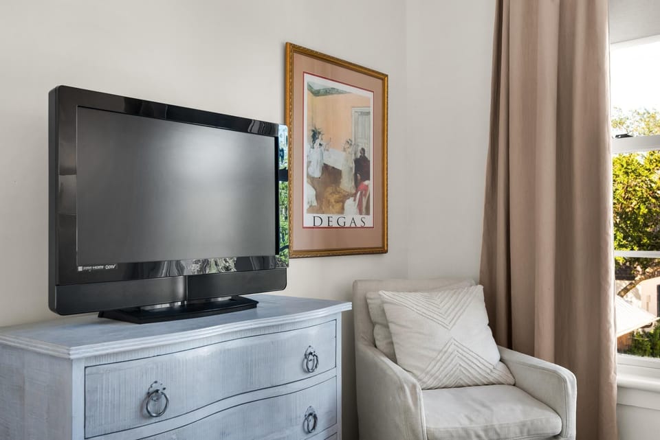 Cozy corner with plush chair and flat-screen TV
