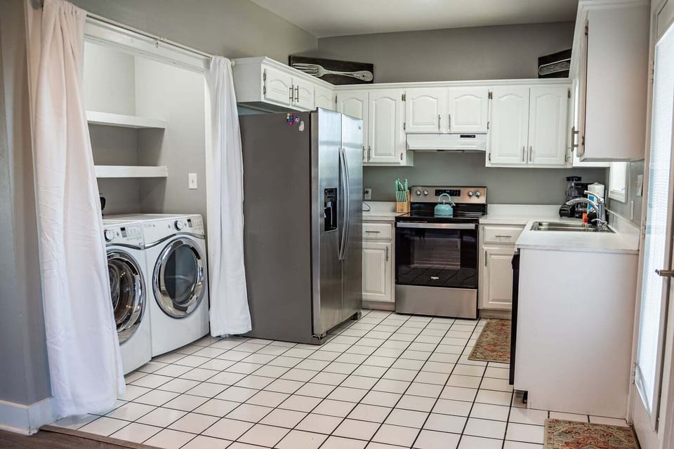 Fully stocked, open kitchen with connection to back balcony door.