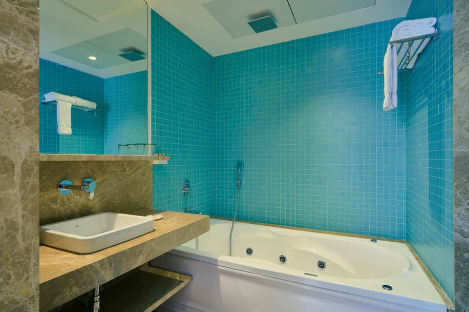 Luxury Suite, 1 King Bed | Bathroom | Shower, free toiletries, slippers, towels