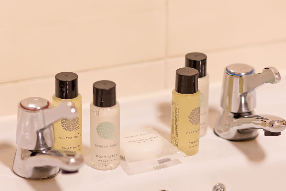 Combined shower/tub, designer toiletries, hair dryer, towels