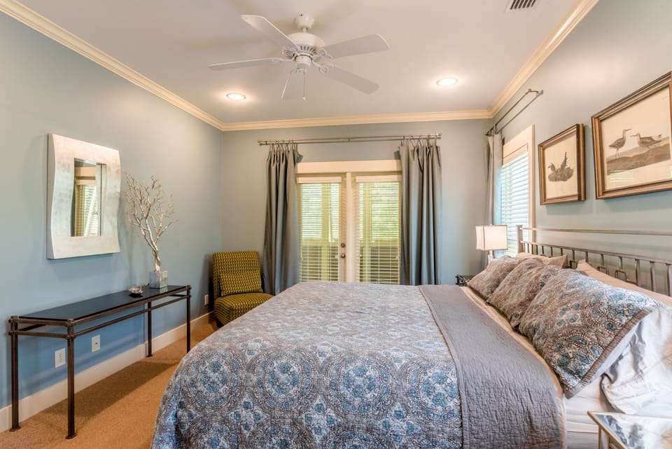 Master Bedroom opens to the front shuttered porch and features a king size bed. 