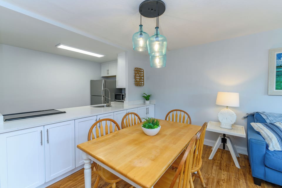 Dining area with coastal charm and elegant lighting fixtures
