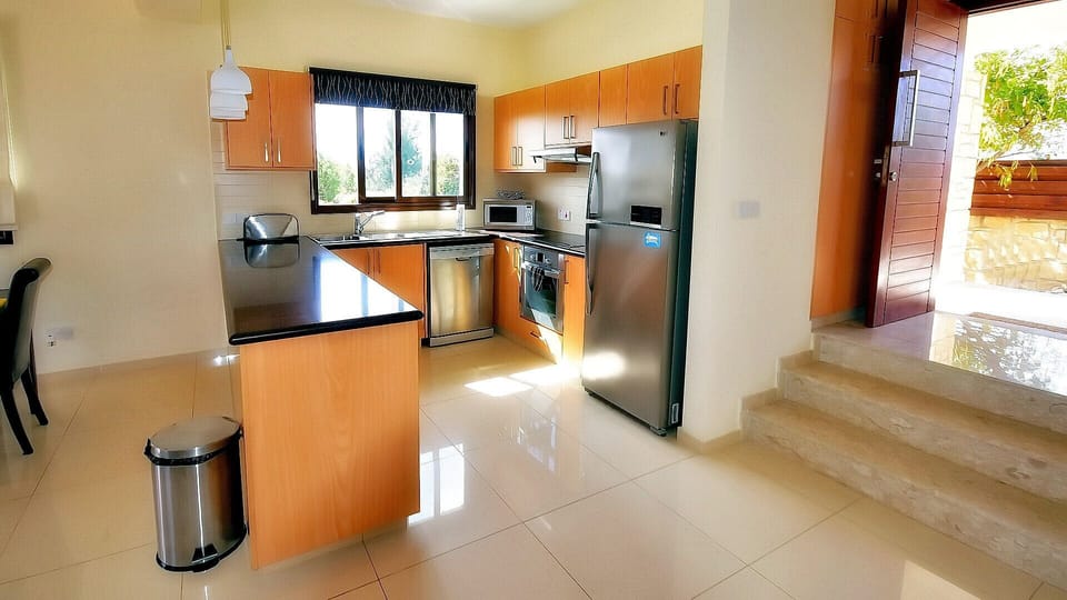 Kitchen includes dishwasher, washing machine, microwave, and all the expected utilities.
