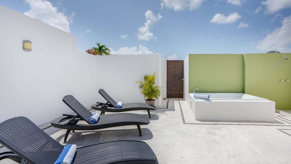 There is a Maya sombra Shade (not pictured) Private rooftop, lounge chairs and tub, door that leads to the rooftop pool
