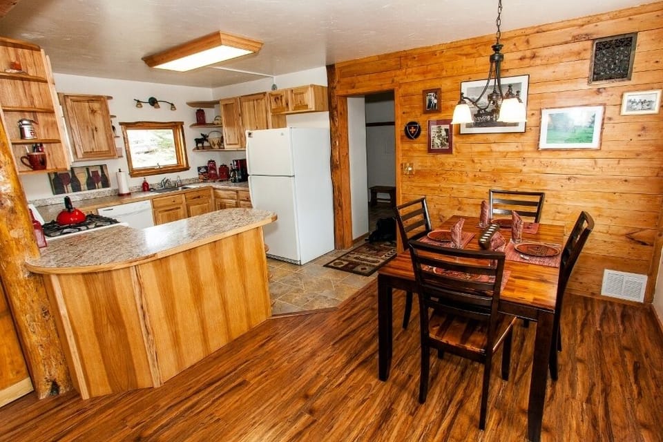 The dining area and kitchen and looking out at entryway