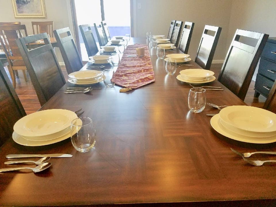 Large dining room opens to kitchen, steps out to outdoor dining and BBQ grill