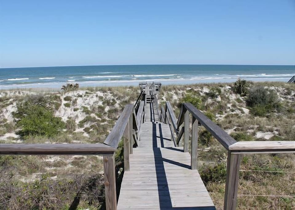 Private boardwalk leading directly to the serene beach and ocean.