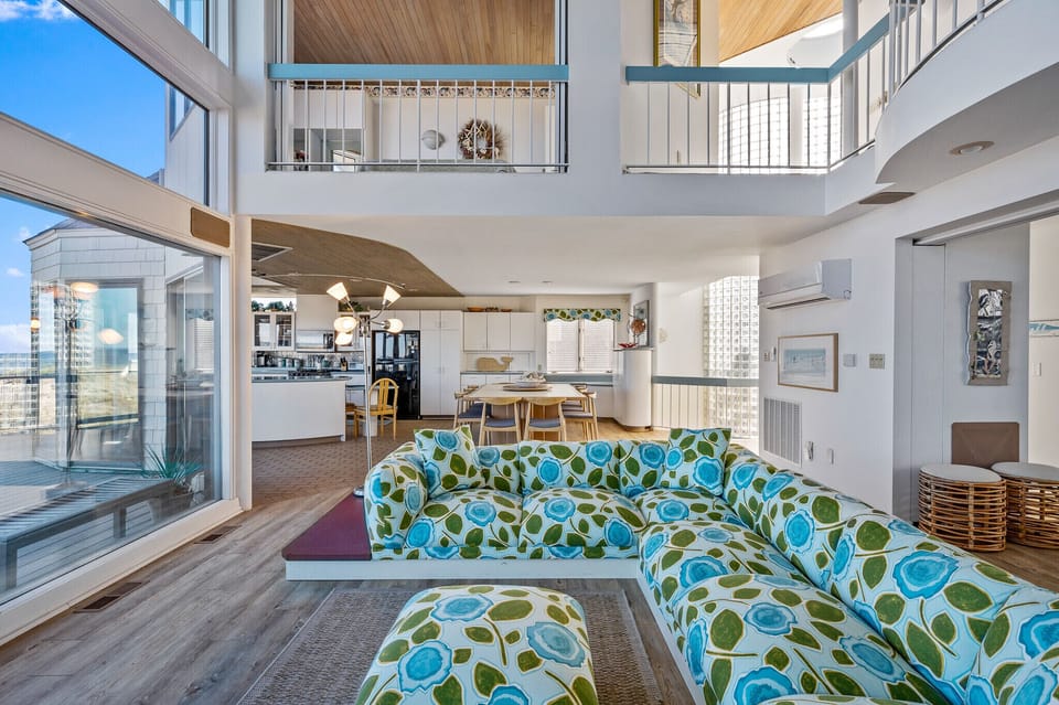 Main living room view of kitchen and upstairs floor plan.