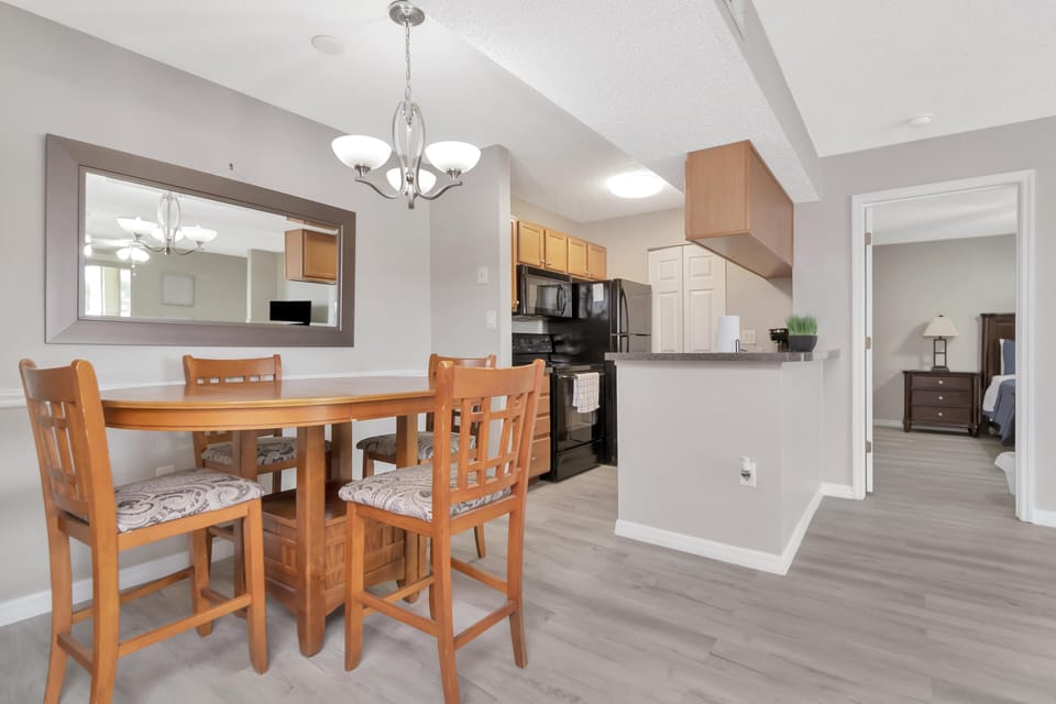 Bright dining area with modern kitchen and open layout