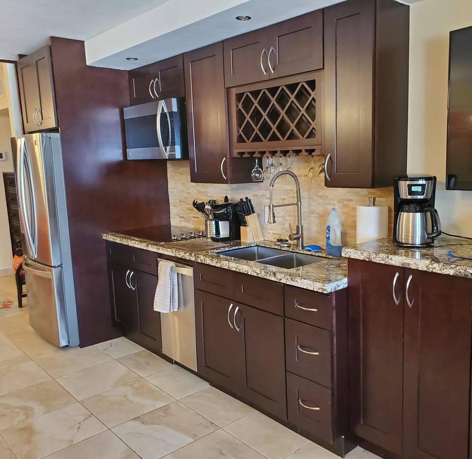 Beautiful new kitchen with refrigerator, dishwasher, stove top, convection oven.