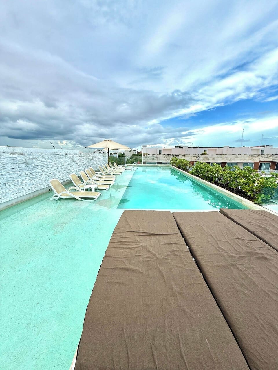 Shared rooftop pool with city views