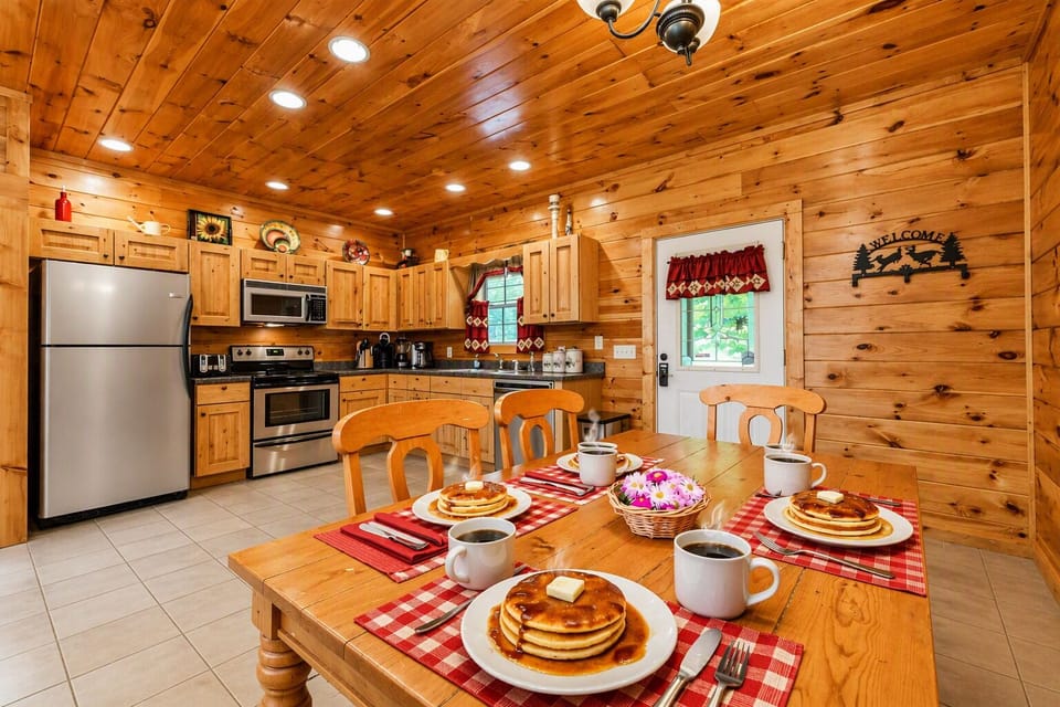 Gather around the six‑person wooden table with four chairs and a cozy bench—perfect for pancakes, coffee, and shared memories