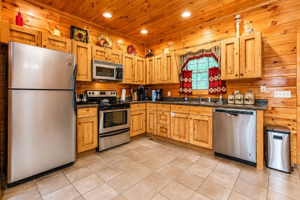 Modern stainless‑steel appliances give the cabin’s kitchen a clean, updated look guests appreciate