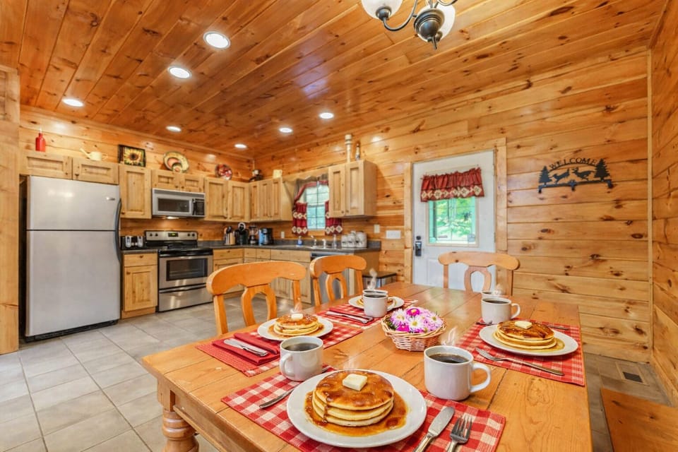 Gather around the six‑person wooden table with four chairs and a cozy bench—perfect for pancakes, coffee, and shared memories