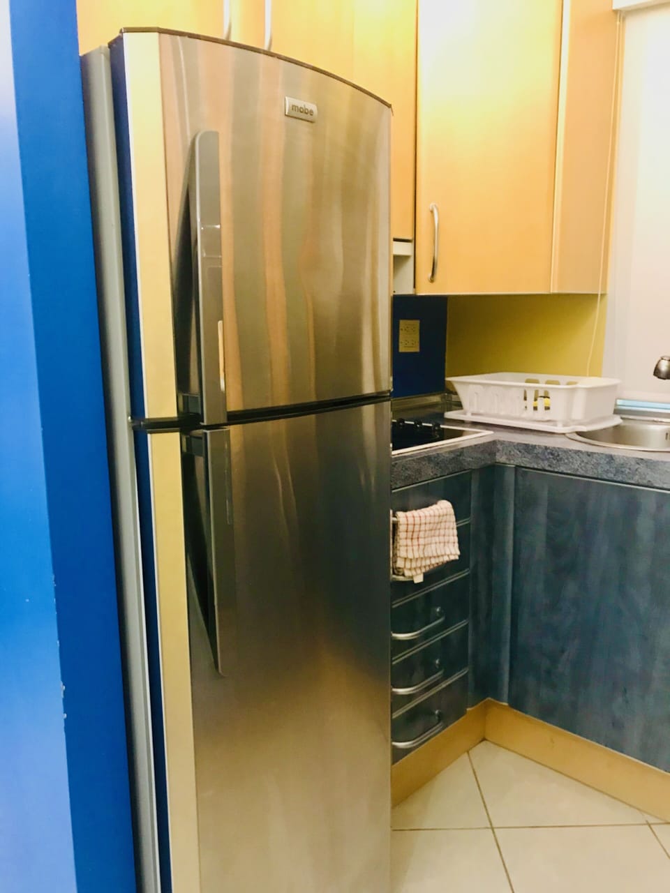 Kitchen with a cooktop, microwave, fridge, coffee maker, toaster, utensils/pots