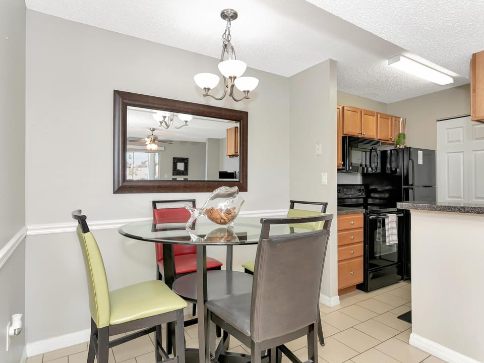 Bright dining area with modern glass table and cozy seating