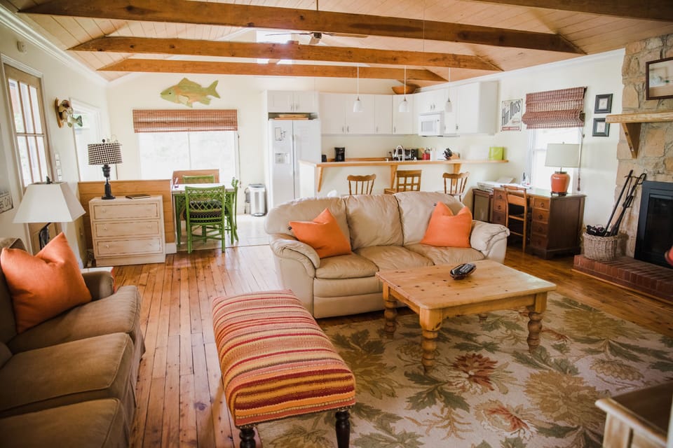 Main floor living and kitchen area. 2 couches, flat screen tv and open kitchen. 
